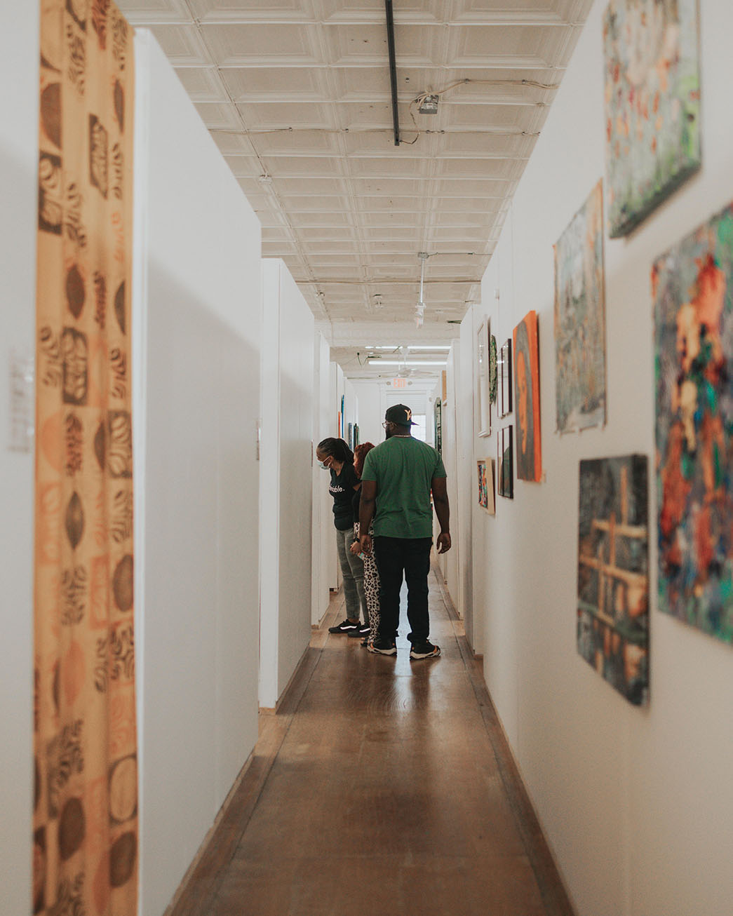 People walking through the hallway of art studios