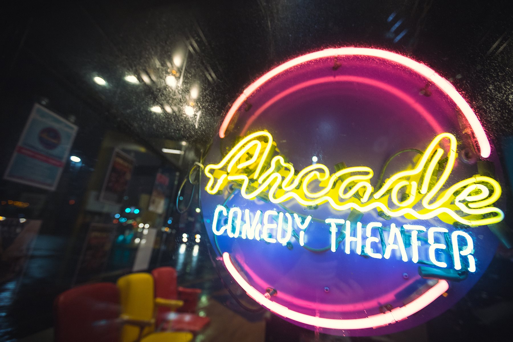 Neon sign reading Arcade Comedy Theater