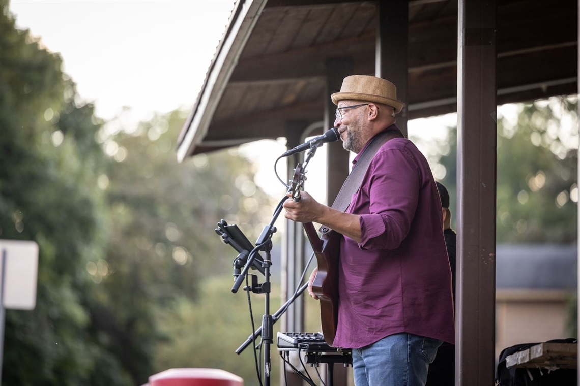 Side photograph of Jimbo Jackson playing guitar and singing